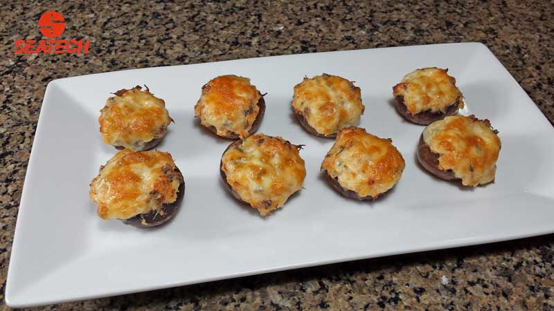 A photograph of crab stuffed mushroom.